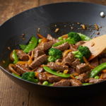 A delicious beef and vegetable stir-fry served in a bowl, garnished with sesame seeds."